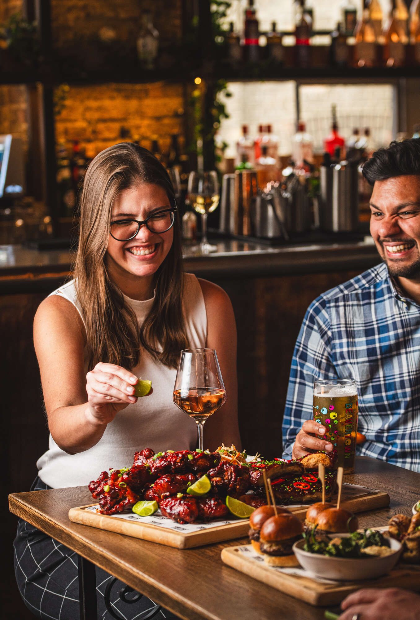 Friends enjoying a sharing platter and laughing together at The Bar in Farringdon.