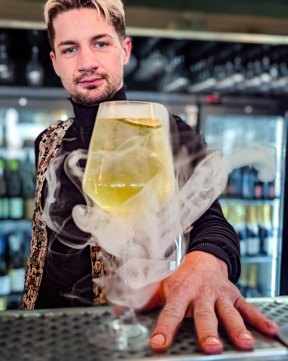 Artistic cocktail presentation with smoke, served at London's best rooftop bar.