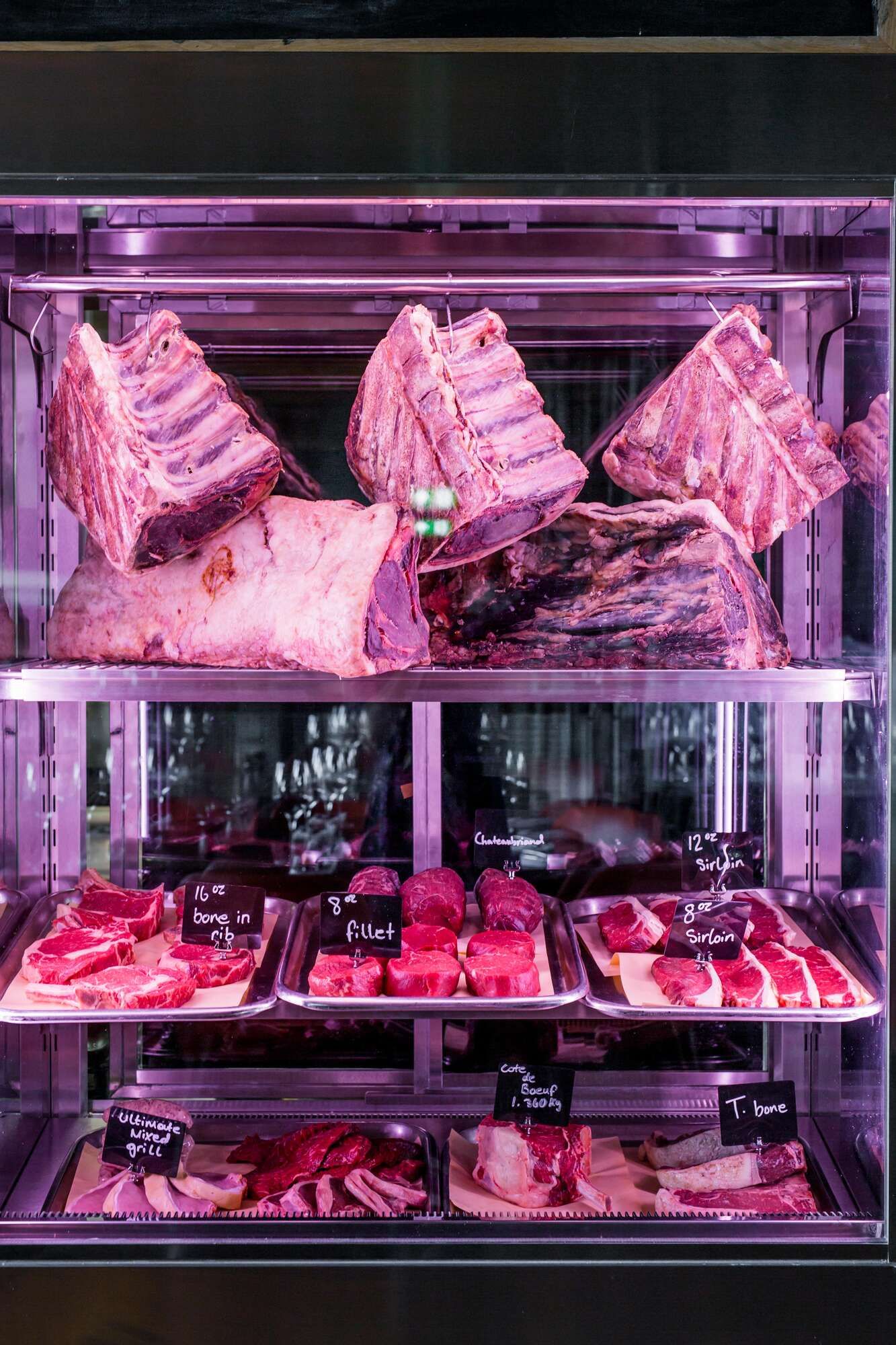 Fresh game meat, sourced from British producers, displayed in a walk-in refrigerator for The Grill's game season menu.