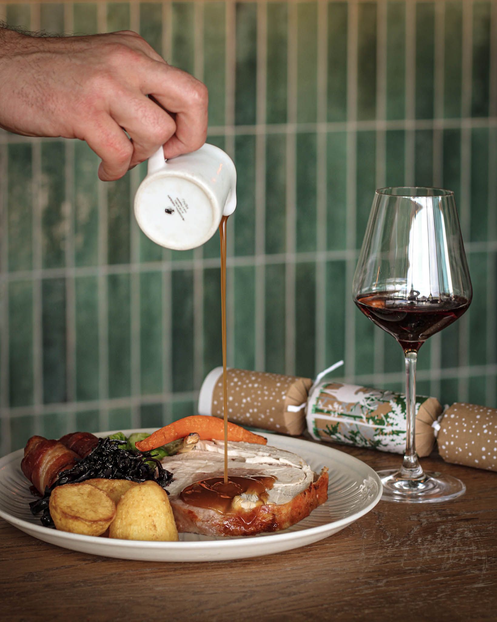 Pouring gravy on a turkey christmas dish at a rooftop restaurant in farringdon