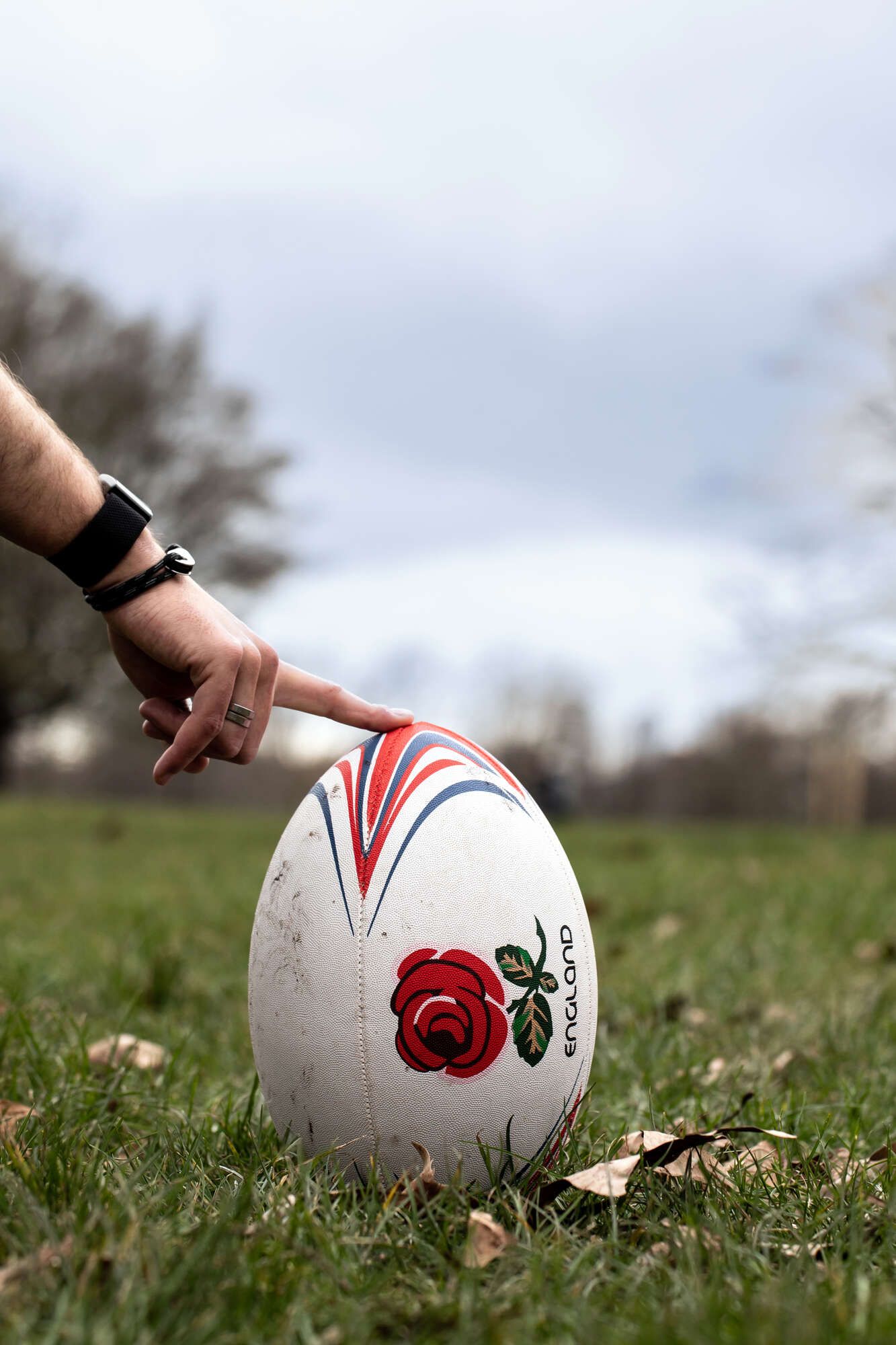 A fan wearing a rugby jersey holding an England rugby ball inside Smiths of Smithfield, the premier destination for Six Nations 2026 group bookings in Farringdon.