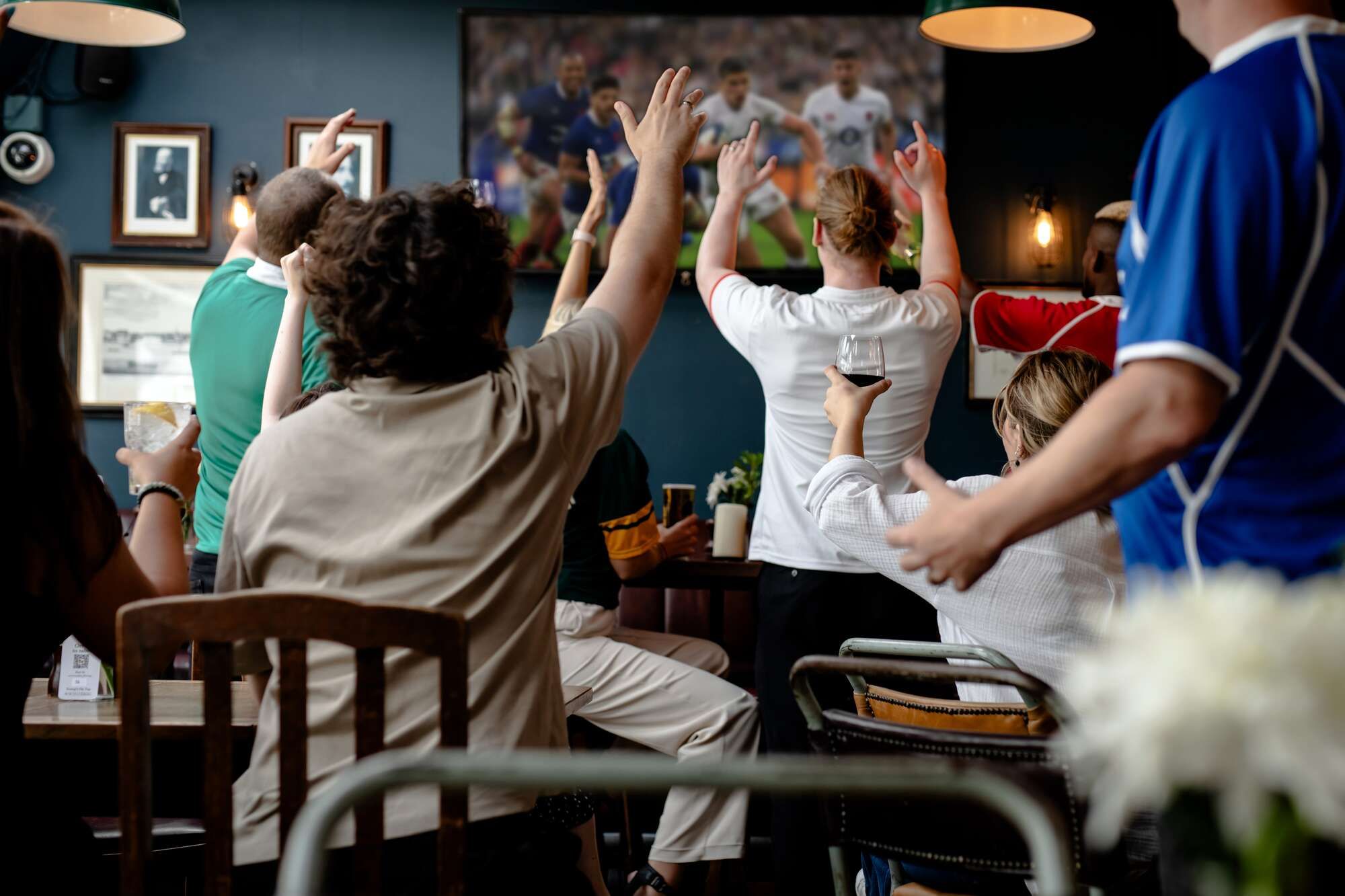 A cheering group of friends enjoying drinks and food at Smiths of Smithfield for a Six Nations 2026 group booking in Farringdon.