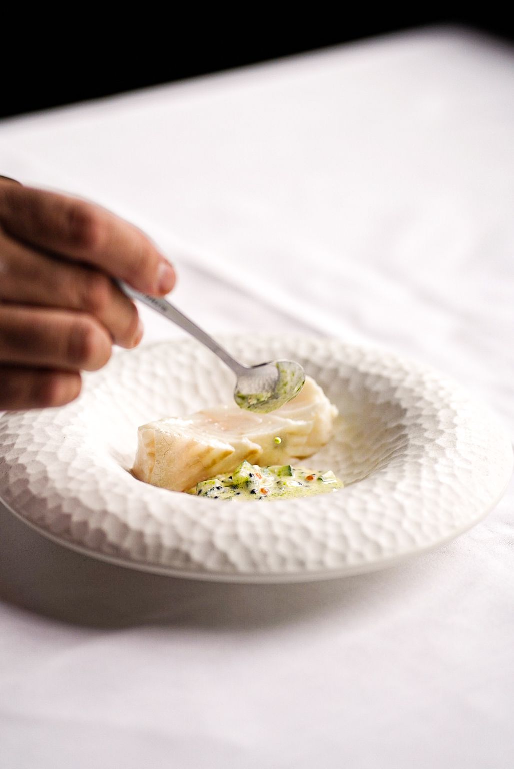 A delicately poached halibut dish served with cucumber, crème fraîche, and Exmoor caviar, part of the 7-course fine dining tasting menu at The Grill.