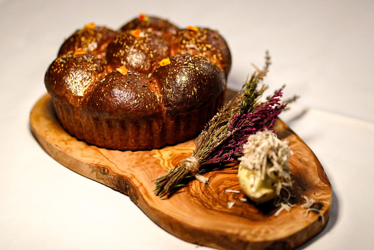 Freshly baked Parker House rolls served with lavender honey and truffle butter as part of the bread course for the 7-course tasting menu.