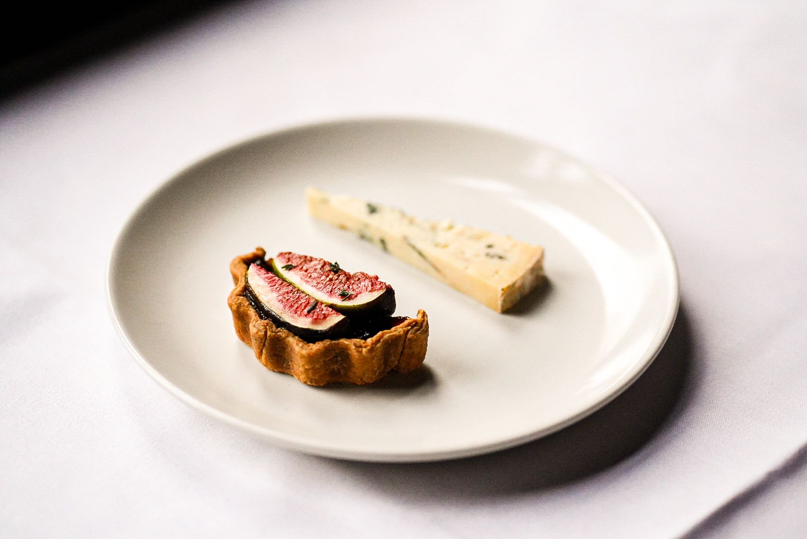 A savoury Cashel blue, fig, and red currant tart served as the optional cheese course supplement for the 7-course tasting menu at The Grill.